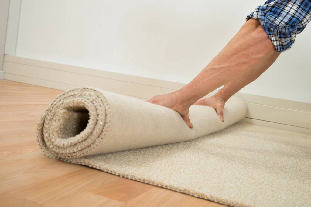 Old carpet being carefully removed from a Chicagoland residence by CSI carpet removal specialists